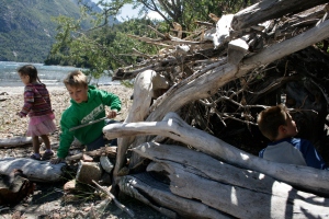 Playing in a driftwood shelter on the beach near Llao Llao